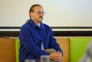 A participant speaking during a panel discussion at an event.