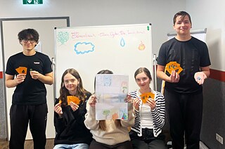 Jugendliche präsentieren Spielkarten.
