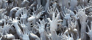 A sculpture of reaching hands
