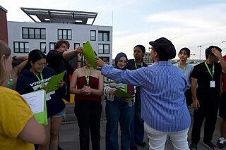 Jugendliche bei einer Urkundenübergabe auf einer Dachterrasse