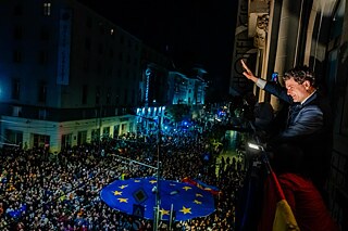 A politician waving from a balcony