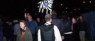A crowd and a floating zebra balloon