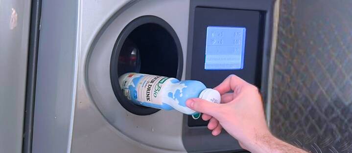 Empty plastic bottles are returned to reverse vending machines in a German supermarket.