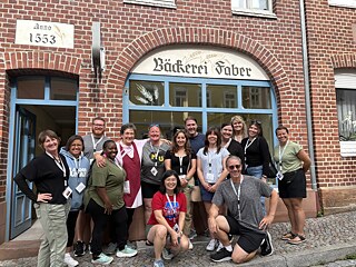 The TOP 1 2026 group poses with Mrs. Schneider baker and owner of the Faber Bakery.