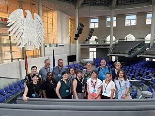 The TOP 1 2026 study tour group poses at the Bundestag plenary hall during their tour of the Reichstag building.
