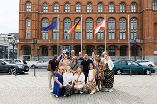 The TOP 3 2026 study tour group poses in front of the Berlin City Hall.