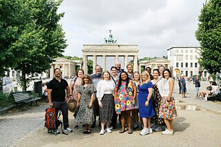 The TOP 3 2026 study tour group poses in front of the Brandenburg Gate.