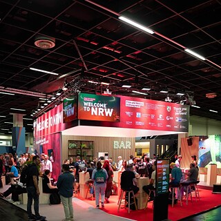Games Connect in Cologne, with visitors gathered at the NRW exhibition and networking area.