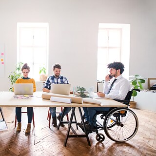 A group of learners sits together at a desk.