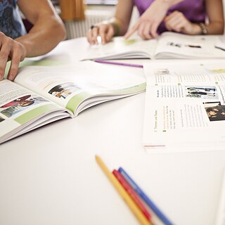 A group of learners sits together at a desk.