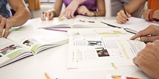 A group of learners sits together at a desk.