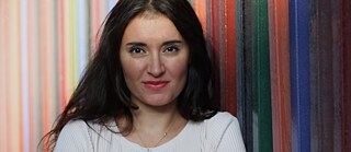Portrait of the artist, dark hair colourful stripy background