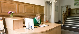 An employee sitting in the reception area at the Goethe-Institut Glasgow.