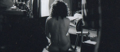 Rückenansicht einer nackten Frau, sitzend