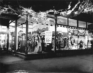 Shop Window, 816 7th Street NW, around 1907. The lights of these shop windows, perhaps readied for the holidays, entice you to consider a fur, a new suit (a steal, really, at $14.95), a new umbrella, or perhaps some 'Practical Presents for Little Folks'.