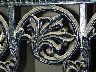 Dusty detail from a school stairway. Ironwork details in the school reveal the care with which Cluss decorated his buildings. (2000)