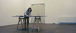 The artist Delia Baillie at work at a desk in a studio