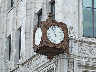 The clock at the corner of 7th and F Streets always marked a convenient place to meet. For years, it was a dusty place for pigeons to land. Now, cleaned, renovated, and working, the clock is reclaiming its former glory as well as its old function, 2015.