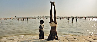 Hatha Yogi Baba with his child at the Ganga