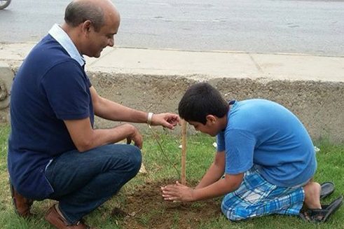 Volunteers of MKG plant a tree sapling near a roadside