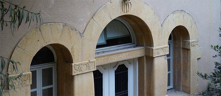 Schlussstein über dem Eingang zum ehemaligen deutschen Pfarrhaus auf dem Campus der École Supérieure des Affaires