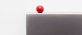 Boule rouge sur une plaque en acier gris