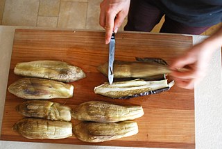 Dice tomatoes and onions, chop parsley and remove seeds from the pomegranate.  Take the eggplants out of the oven and peel off the skins. 