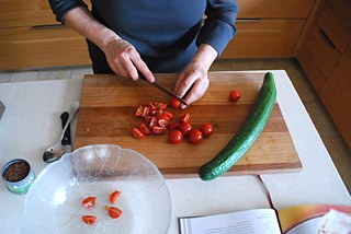 Wash and dice tomatoes and cucumber. Chop the garlic very fine or use a garlic press. Chop the parsley and mint.