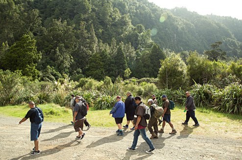 Charles Royal and a group for the food tour walk into the bush near Lake Rotoiti. 