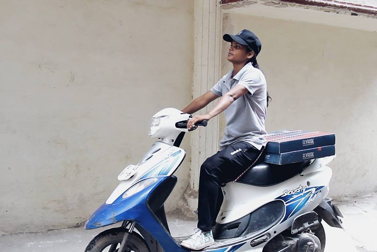 Sunita on her delivery scooter