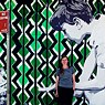 The Street Art Artist Mandy Schöne-Salter in front of her work ‘Imagine‘ (2015). This is a stencil and paste-up artwork created for the Avalon Art Carnival 2015. The work envisages the imaginary worlds children enter during playtime. 
