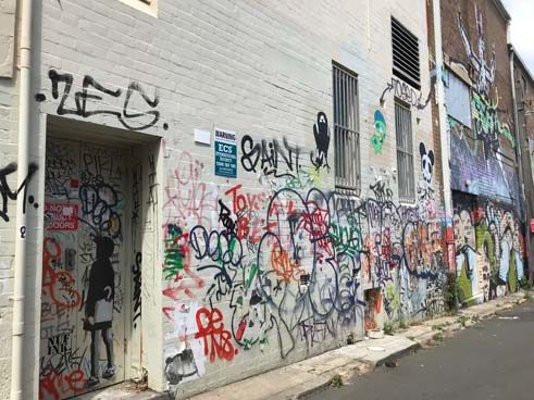 A wall in Newtown covered in tags.