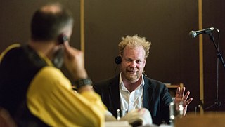 Actor Andreas Tschernek in coversation with renowned Czech economist Tomáš Sedláček.