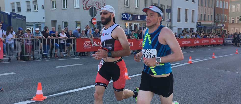 Zwei Männer joggen durch die Stadt.