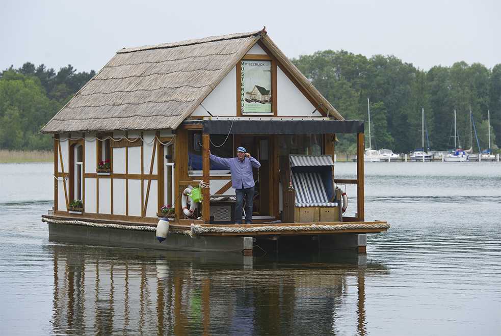<b>Floating half-timbered house in Brandenburg</b><br>Real estate agent Harald Busse’s houseboat rocks gently on the waves of Scharmützel Lake in Wendisch Rietz, Brandenburg. Busse outfitted his floating, half-timbered home with a bath, toilet, and living room and has sailed it on the waters of Brandenburg since 2010. This aquatic motorized home is officially licensed as a sports boat.