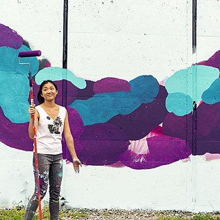 Wing Chow works on her mural for POW! WOW! DC 2018