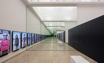 The “Wall of Opinions” video installation gives voice to people living with physical divides today.  