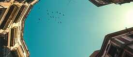 A view of a blue sky between houses