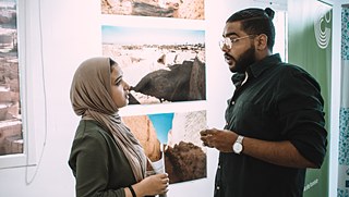 The artist Mohamed El-Bosifi talking to a visitor
