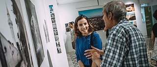 Journalist and photographer Heba Alshibani standing with a visitor