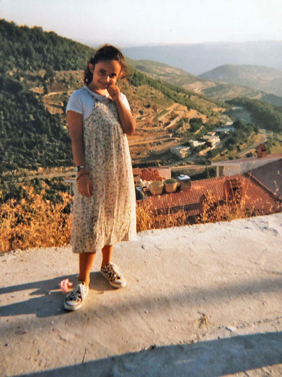 Huda Al-Jundi als junges Mädchen vor einem Dorf in Syrien