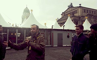 Walking tour guide Taylor with a group at the Gendarmenmarkt Christmas Market. 