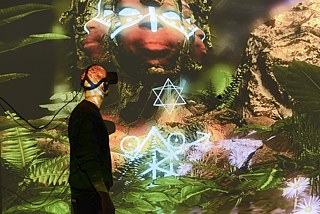 Apmeklētājs iepazīst VR mākslas darbu ”THE UNFRAMED WORLD” mākslas centrā House of Electronic Arts Šveices pilsētā Bāzelē 2017. gadā, kuratore – Tīna Zauerlendere no ”peer to space”. 
