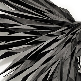 An artistically folded top looks like the wing of a bird.