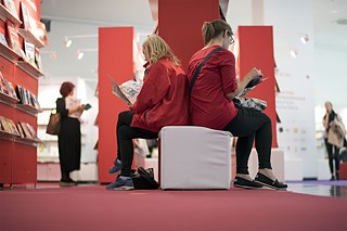 Two women browse back to back at the Frankfurt Book Fair, where the German Book Prize is awarded. Women account for two thirds of the novel-reading public in Germany. 
