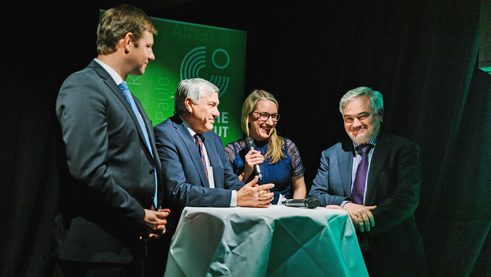 Erle Marie Sørheim speaking with Thomas Erndl and Alois Karl, members of the Bundestag (left), and Ambassador Alfred Grannas (right)