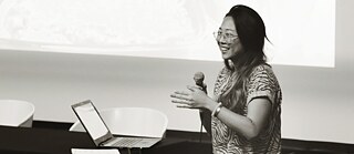 Jennifer Katanyoutanant (Thailand)<br> Katanyoutanant's research centres on the impact of YouTube's deep learning algorithm on the environment. With a focus on <i>mukbang</i>, a South Korean trend that shows hosts eating large amounts of food, Katanyoutanant highlights the effect of seafood <i>mukbangs </i>on the fishing ecosystem in Southeast Asia. Based on research showing that more than half of Southeast Asian users water over 10 hours of YouTube every week, Katanyoutanant posits YouTube as an effective tool for cultural imperialism while simpultaneously investigating the architecture that promotes these trends and uncovering the material impact of the Internet. Alongside an overall goal to explore the connections between individual action and global, social, economic, and encironmental issues, and to show the ways in which they are mediated through tech/media platforms such as YouTube, Katanyoutanant's research also takes on a speculative edge in its artistic manifestation: enacting the <i>mukbang </i>format of presentation, her work imagines and juxtaposes an alternative menu of plant-based foods that Singaporean and Filipino society will turn to should the Southeast Asian fishing ecosystem collapse.<br /> <a href="javascript:contensActPage('openpage',894126,{linktype:3,inst:6066459,aname:'#i6066459'});" linkid="1823429">More about Jennifer Katanyoutanant</a>