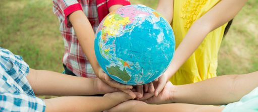 Children hold a globe
