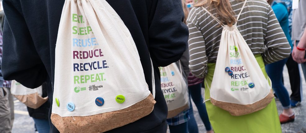 Cotton and cork drawstring bags with the slogan "Eat. Sleep. Reuse. Reduce. Recycle. Repeat"