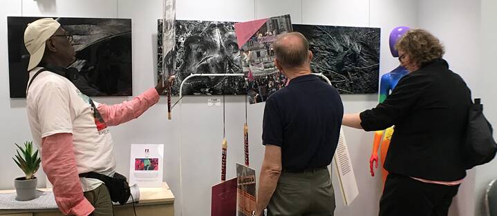 Exhibit pieces and guests at the mini exhibit at the DC Center for the LGBT Community.